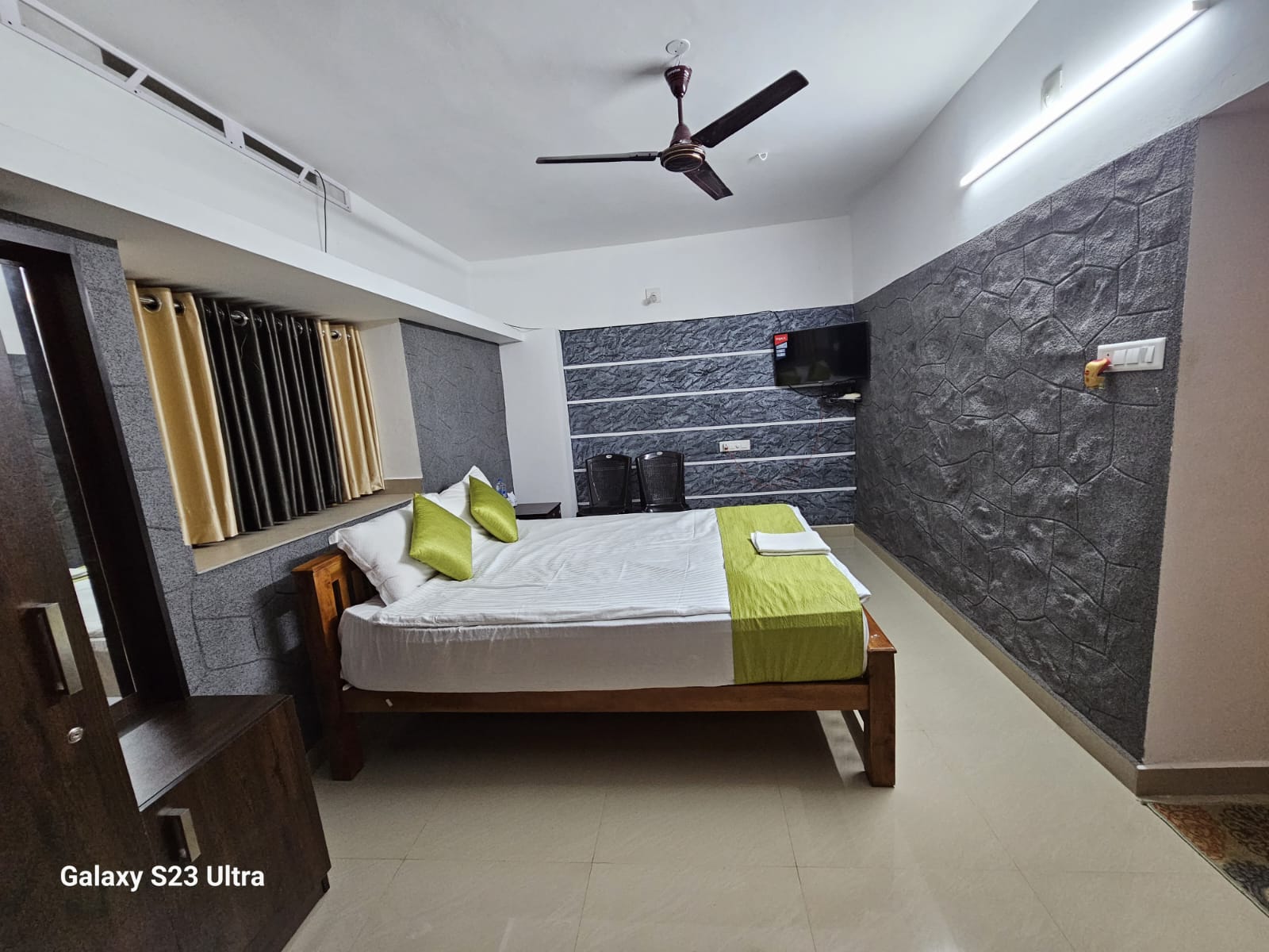 Spacious guest bedroom with twin beds and mountain view windows